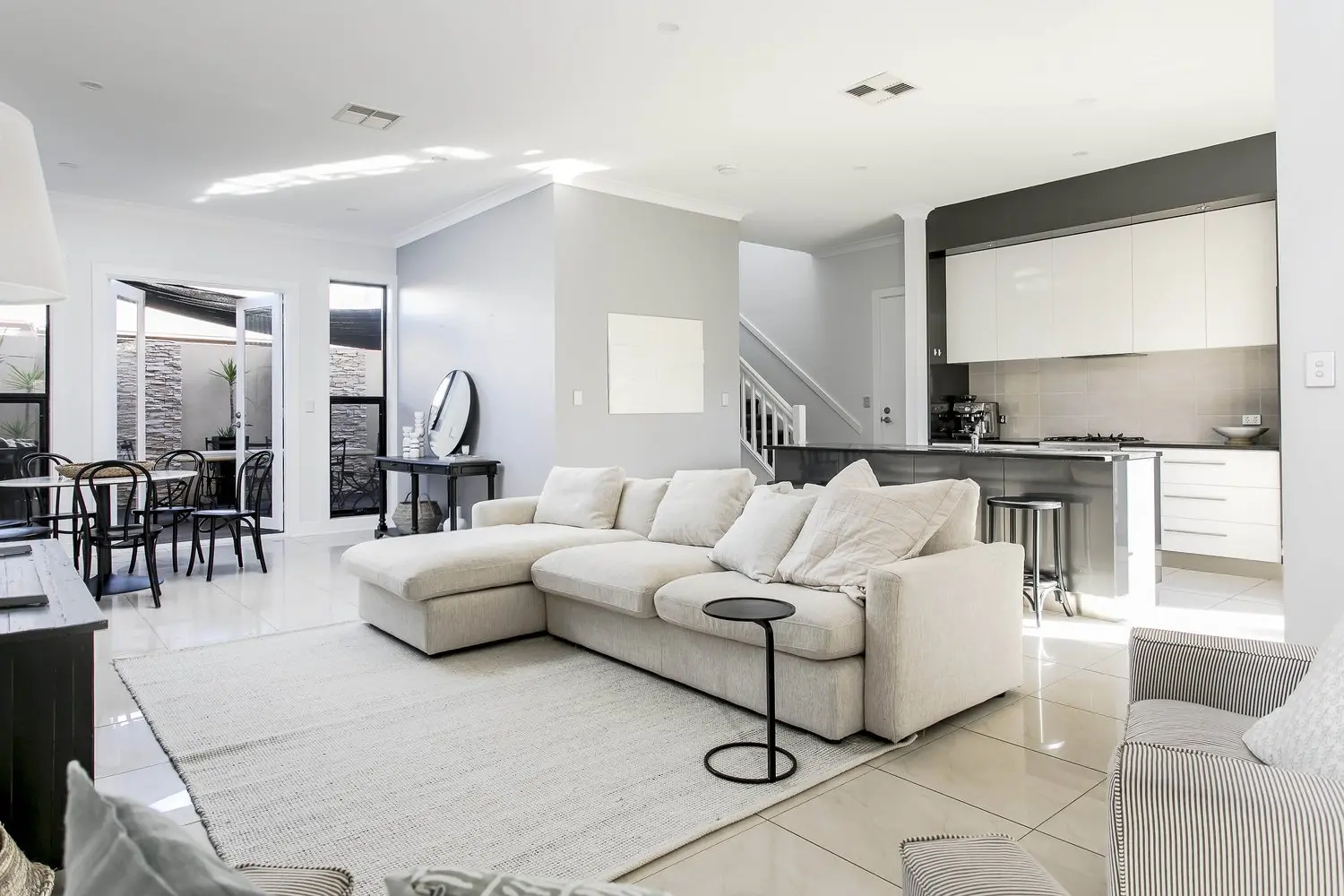 Prestine white lounge room inside of Elite Accommodation holiday rental